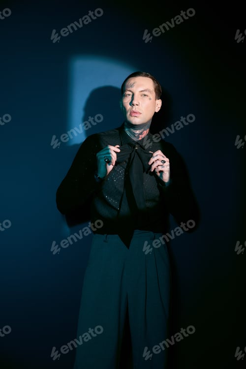 Preview: Handsome young man showcases stylish attire in artistic setting with dramatic lighting