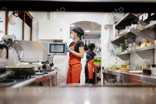 Preview: Masked cooks preparing food