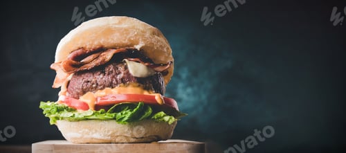 Preview: View of fresh tasty burger on wooden table. Hamburger with bacon, cheese, lettuce, tomato and sauce