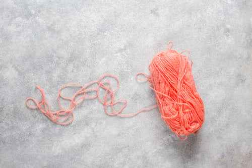 Preview: Balls of yarn in different colors with knitting needles.