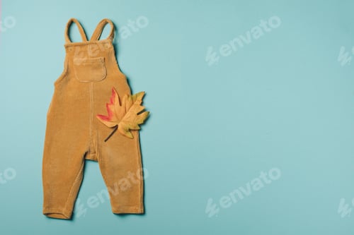 Preview: Mustard baby romper, yellow autumn leaves on blue background