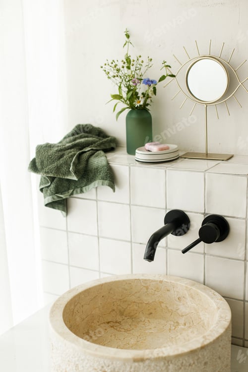 Preview: Beautiful flowers bouquet in modern marble sink in stylish bathroom
