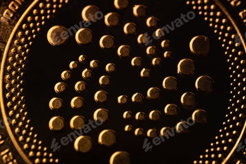 Preview: top view extreme macro closeup of crypto IOTA golden coin logo