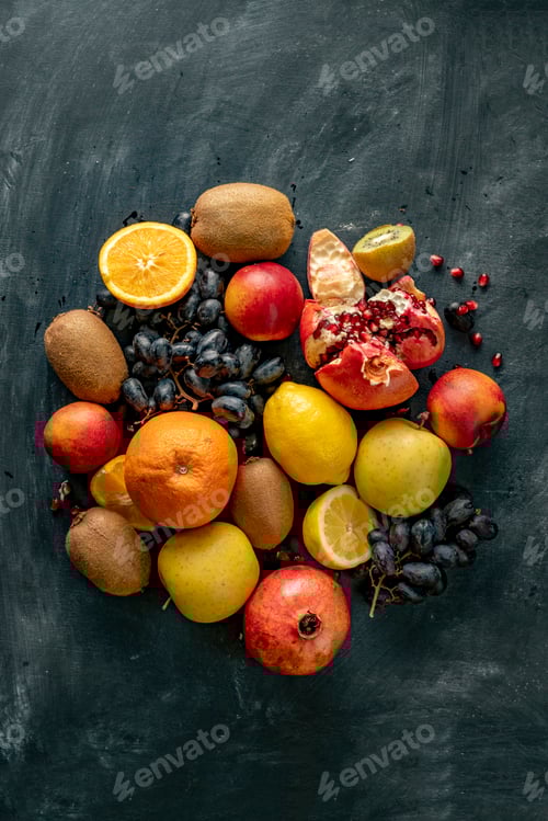 Preview: flat lay fresh fruit selectrion layout on a grunge surface such as grapes, kiwi, orange