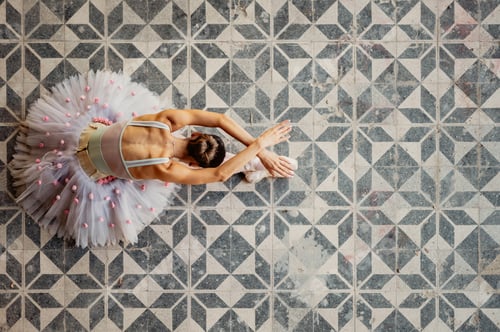 Preview: Top view of an elegant ballet dancer performing her art at abandoned place.