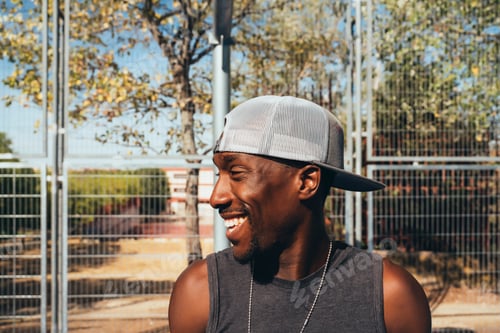 Preview: African man with cap on the street smiling