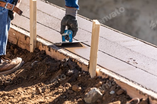 Preview: Construction Worker Using Hand Groover On Wet Cement Forming Coping Around New Pool