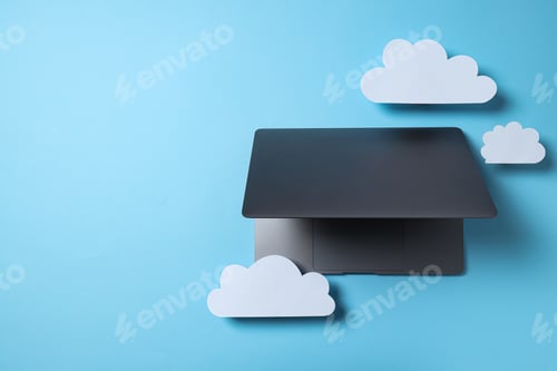 Preview: Laptop with paper clouds on a blue background, place for text