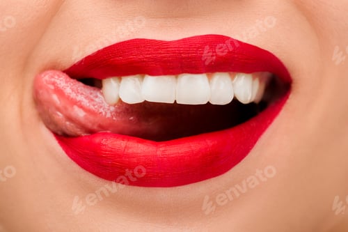 Preview: cropped view of cheerful woman with red lipstick sticking out tongue isolated on white