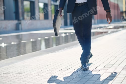 Preview: Close up of a man in a suit walking on the street
