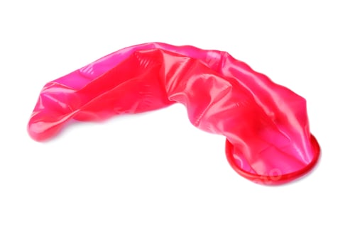 Preview: Red used condom on white background. Safe sex concept