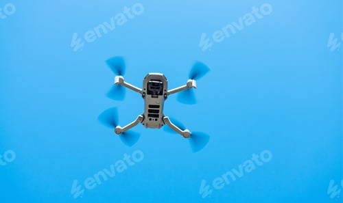 Preview: Consumer drone with camera hovering against sky