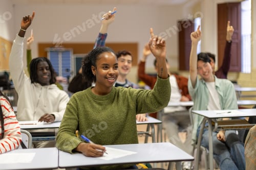 Preview: Diverse high school students raising hands in classroom