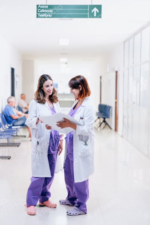 Preview: Two young happy female doctors working together in a hospital