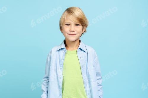 Preview: Handsome cute little boy wearing casual clothes looking at camera posing isolated on blue background