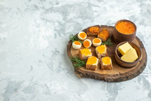 Preview: front view tasty caviar sandwiches with boiled eggs on wooden board white background breakfast toast