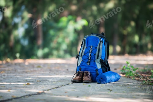 Preview: Backpack and shoes backpackers rest on the road while go hiking.