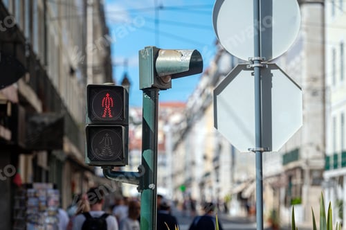 Preview: Red pedestrian signal guides foot traffic on a busy city street during daylight hours