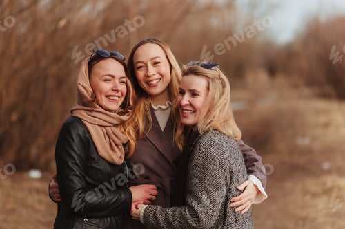 Preview: Three girls huging and laughing countryside
