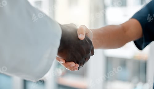 Preview: Two doctors shaking hands while working together at a hospital. Medical professionals greeting each