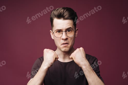 Preview: Determined furious man holding fists up
