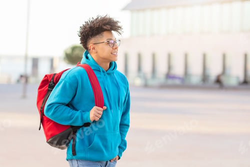 Preview: Student walking with backpack and looking away