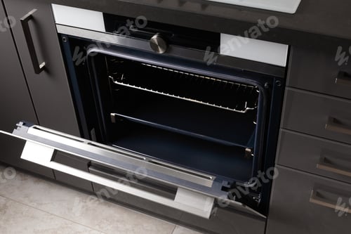 Preview: Built-in electric oven with open door in the kitchen.