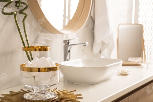 Preview: Decorative jar with cotton pads on modern countertop in bathroom interior
