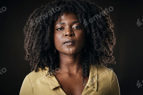 Preview: Cropped portrait of an attractive young woman posing in studio against a dark background