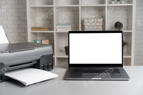Preview: Printer and laptop on grey table in office