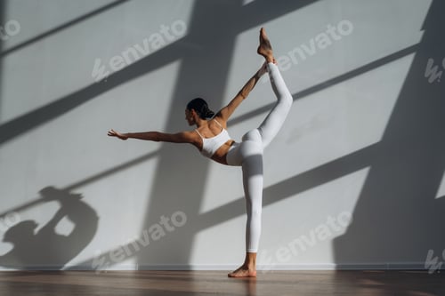 Preview: Legs are stretching, yoga exercise. Beautiful young woman with slim body type is indoors