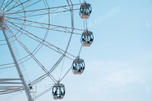 Preview: white Ferris wheel against a blue sky. amusement park in summer.