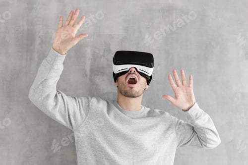 Preview: Man Experiencing Virtual Reality With Arms Raised