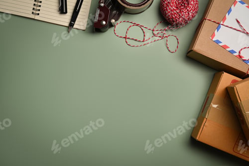 Preview: Cardboard boxes, tape and clews of rope on green background.