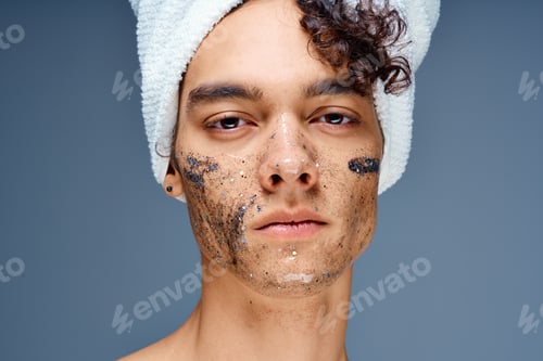 Preview: Cheerful guy with a towel on his head cosmetics on the face clean skin