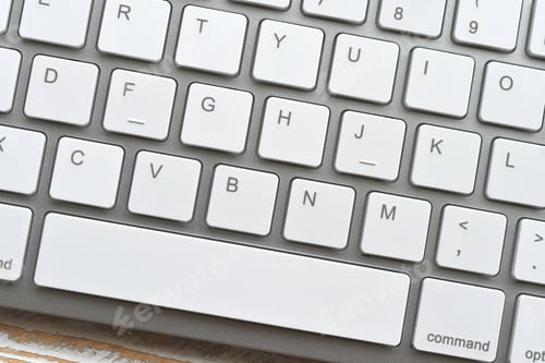 Preview: Closeup full frame of white computer keyboard suitable for a background image.