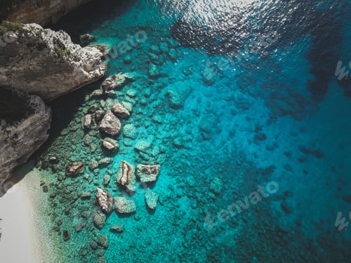 Preview: Aerial view of rocky cliffs and turquoise waters on a sunny day on Zakynthos Island in Greece