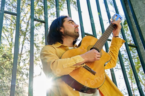 Preview: Man Plays Guitar on Sunny Urban Afternoon