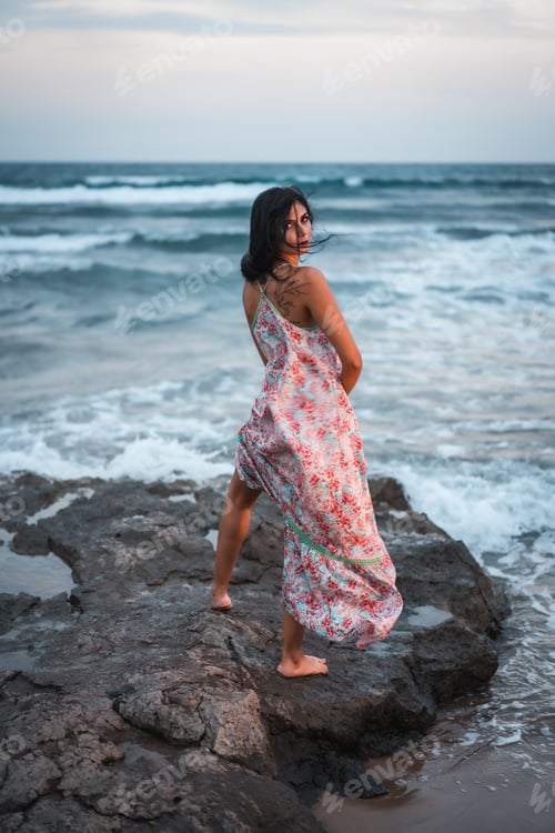 Preview: Posing of a brunette Caucasian in a white fabric dress with flowers
