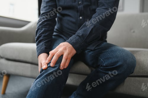 Preview: people, health care and problem concept - unhappy senior man suffering from knee ache at home