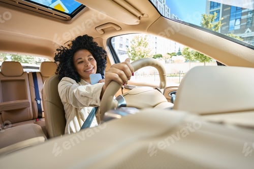 Preview: Female drives a comfortable car and talks on the phone