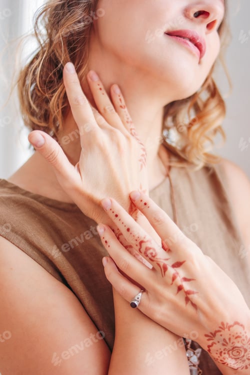 Preview: Crop portrait of beautiful young woman in linen dress with mehendi on hands, eco natural beauty