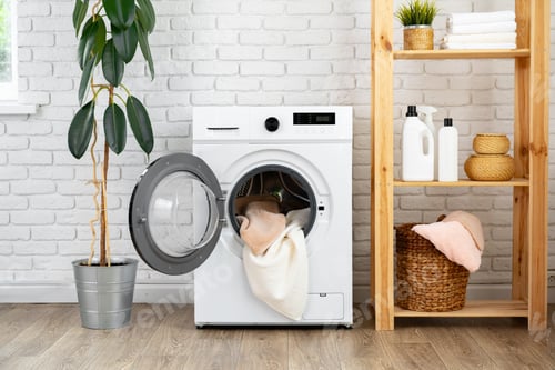 Preview: Modern white washing machine close up photo
