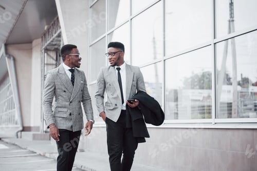 Preview: Business communication. Two cheerful business men talking to each other and discussing a project