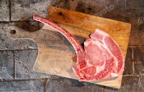 Preview: Raw tomahawk steak on cutting board