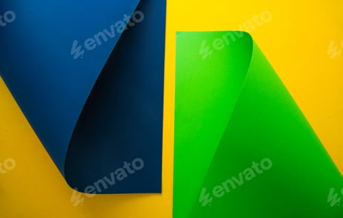Preview: Vibrant blue and green paper shapes contrasted against a yellow background in a minimalist design