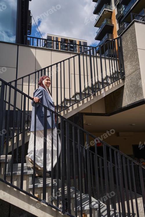 Preview: Beautiful arab woman in a jacket descends the stairs
