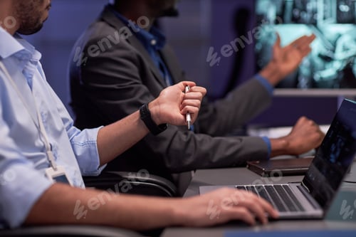Preview: Unrecognizable man using laptop in meeting
