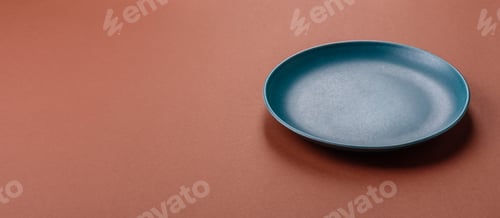 Preview: Empty ceramic plate on a monochrome brown background