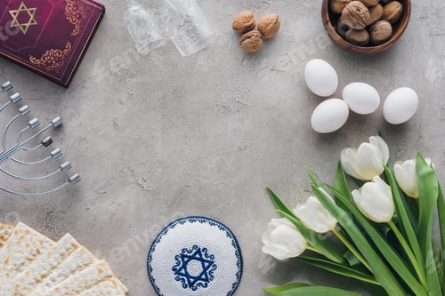 Preview: top view of traditional book with text in hebrew, kippah and menorah on concrete table